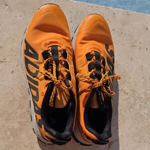 Adidas Vigor 6 TR trail running shoes in orange and black. 